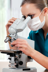 Female medical doctor using microscope in a laboratory